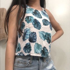 white tank with bluish-green leaves